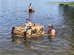 camper in constructed boat floating in water