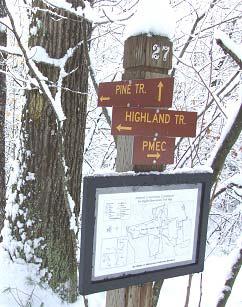Trail identification with trail signs, map and location number.